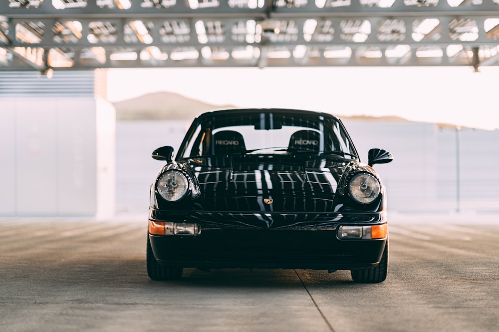 a black car parked in a parking garage