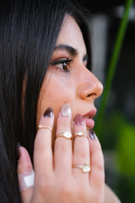 a close up of a person with a ring on her finger