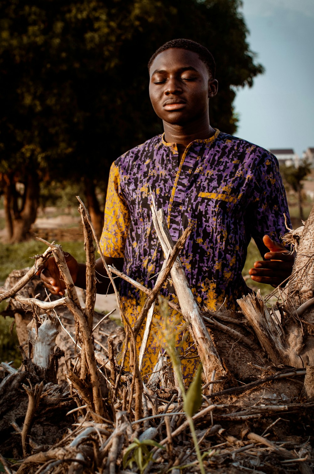 a man standing in a pile of branches