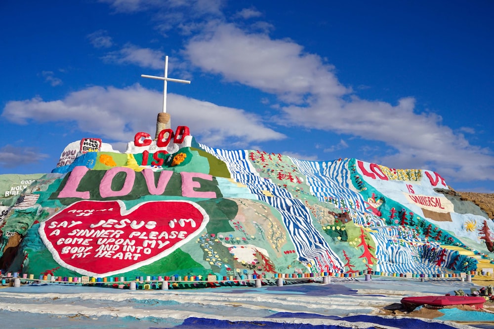 a large colorful building with a cross on top of it