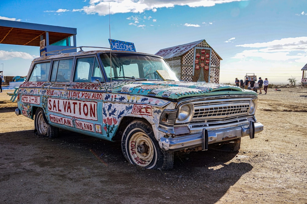 an old station wagon painted with a lot of stickers