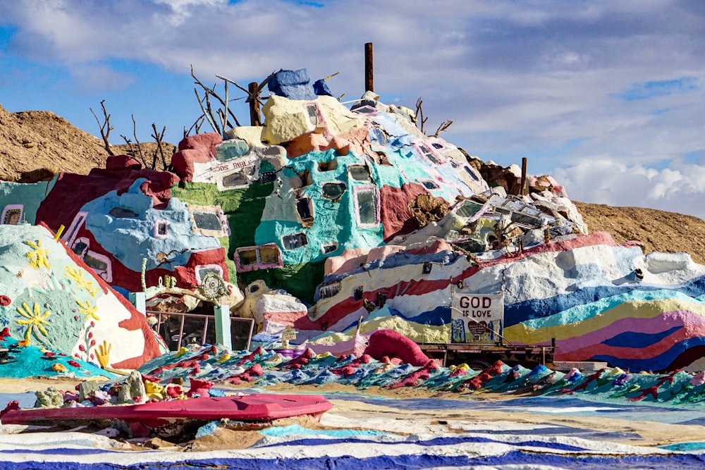a large pile of colorfully painted rocks in the desert