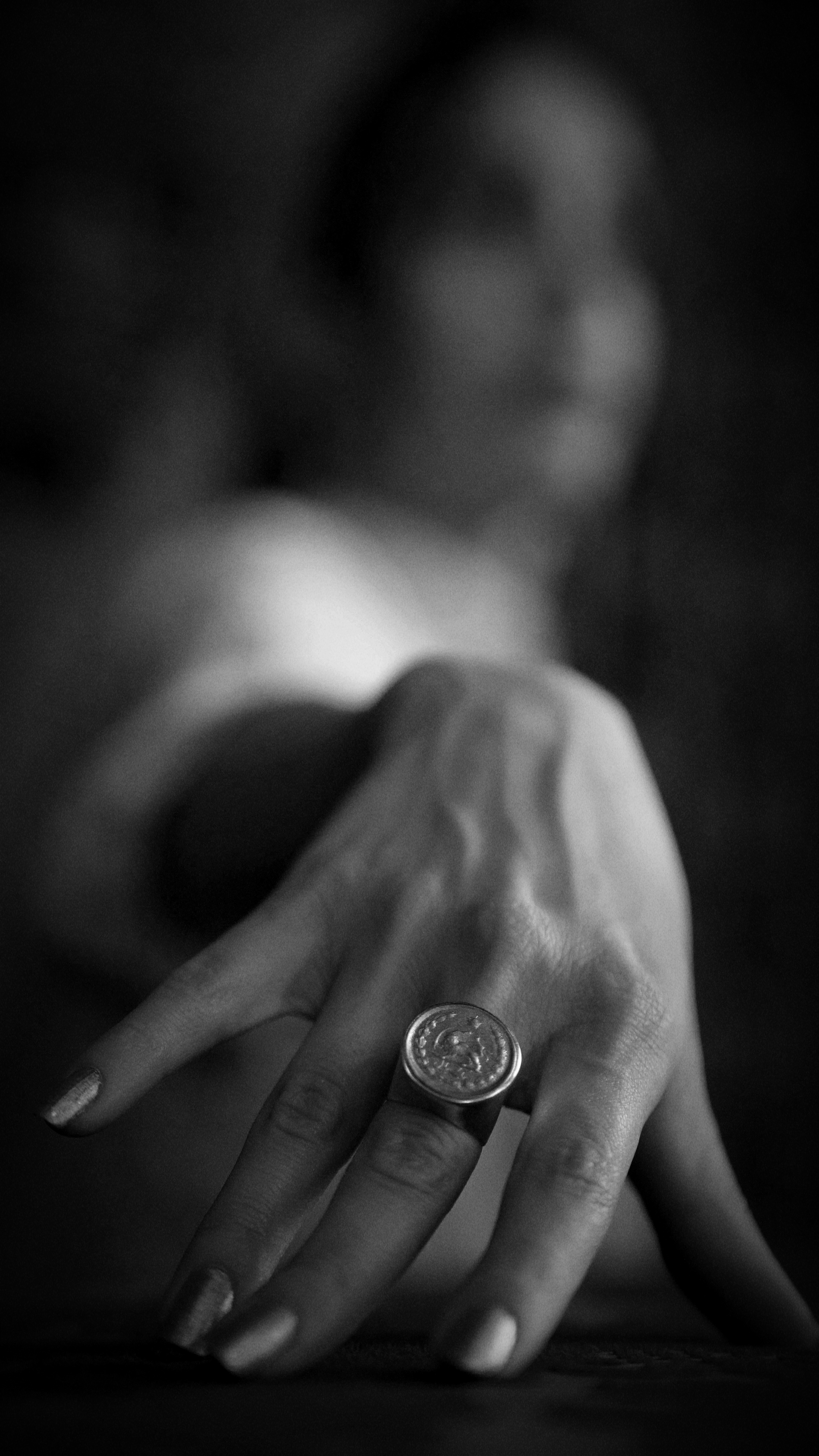 a woman's hand with a ring on it