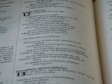 A close-up of a page from a book displaying text related to 'Songs of Praise' in chapter 12. The text is clearly printed and arranged in paragraphs, with numbers indicating verses or sections. The page appears to have a slightly yellowed hue, suggesting age or use. The text is in English and the font appears classic and serifed.