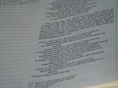 A page from a book, displaying text on the right side, while the left side is blank except for evenly spaced horizontal dots. The text is formatted in a justified style with numbers for each line, indicating a structured layout, likely from a religious or reference book.