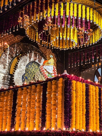 Close-up of vibrant marigold and jasmine flower garlands draped elegantly around a traditional chapra entrance.