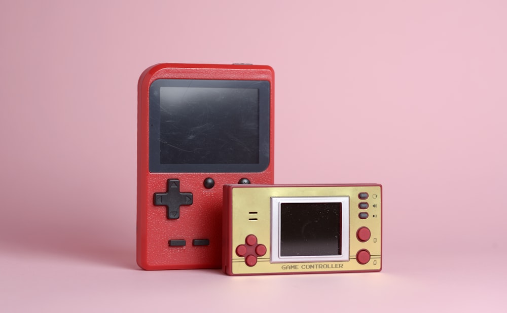 a red nintendo game boy next to a red box