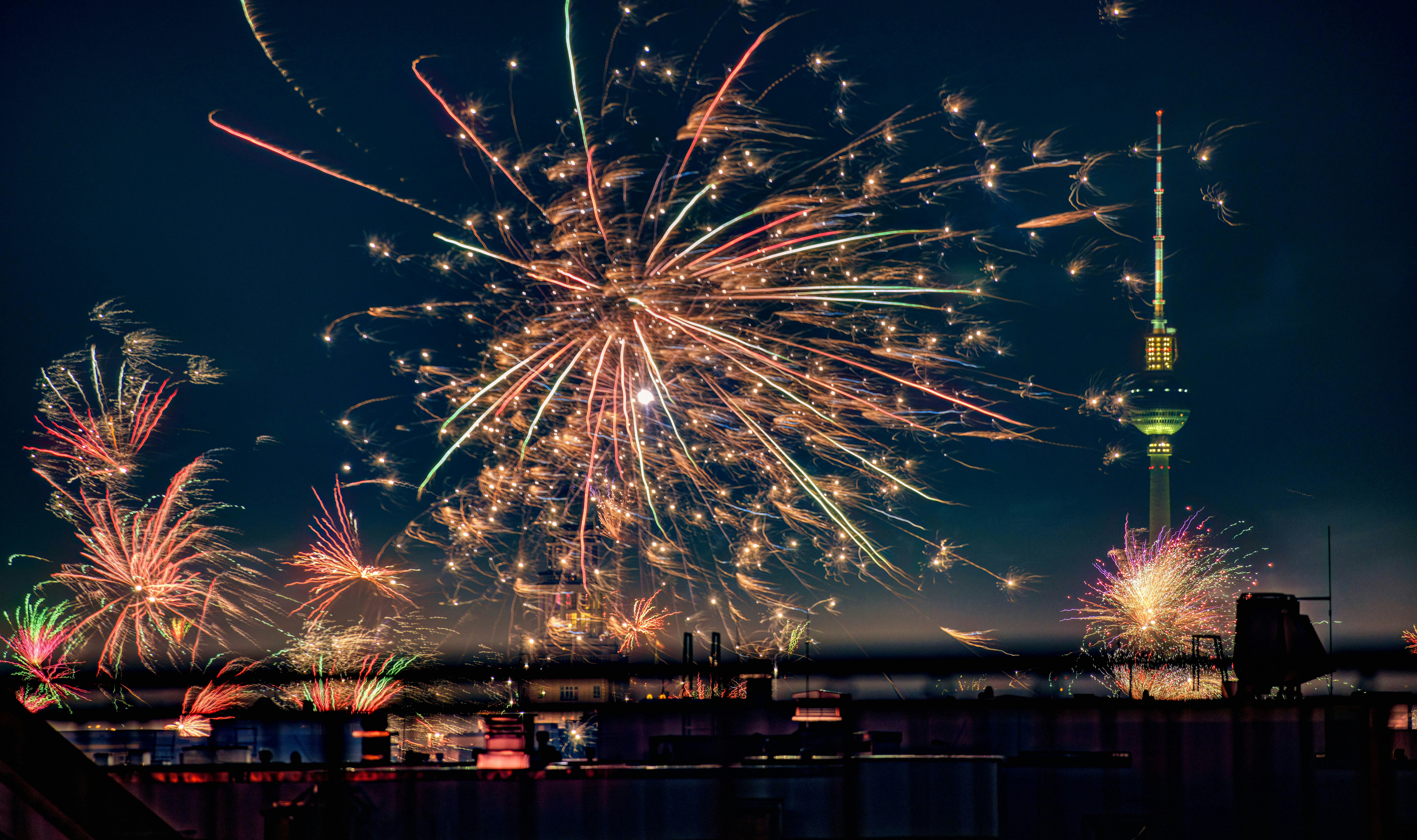 fireworks are lit up in the sky above a city