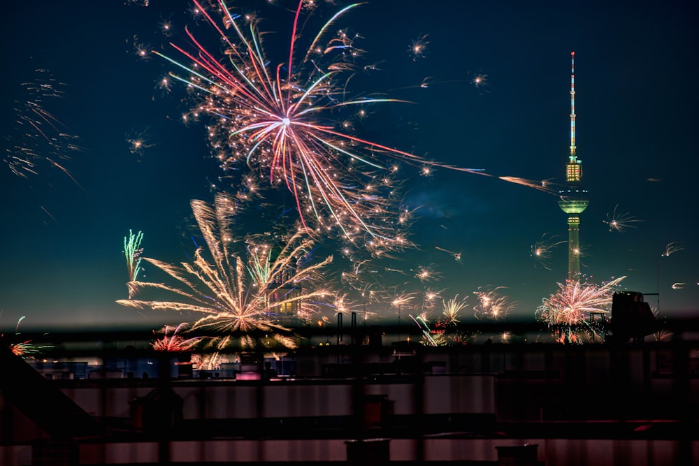 fireworks are lit up in the sky above a city