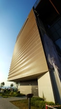 The school building’s modern facade under a clear blue sky, accented with navy blue details.