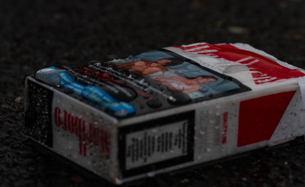 a box of cigarettes sitting on the ground