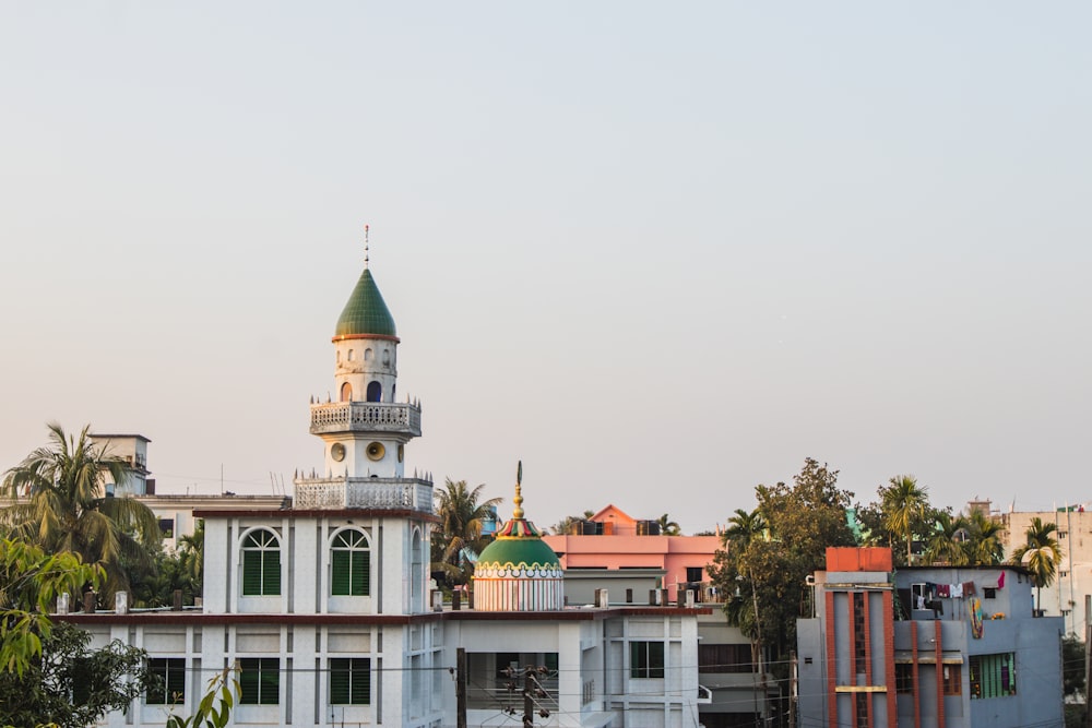 a large white building with a green dome