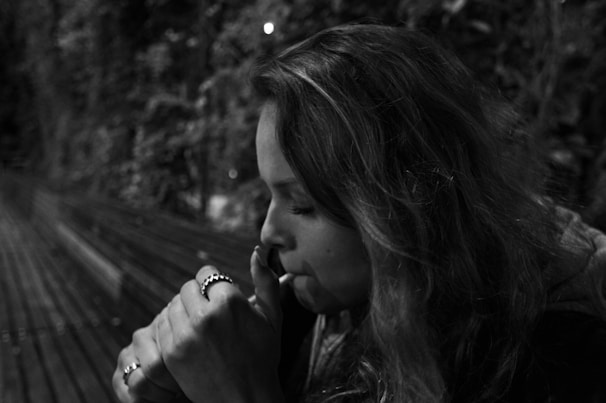 A candid shot of Thom reflecting quietly on a bench, capturing the theme of sin and redemption.