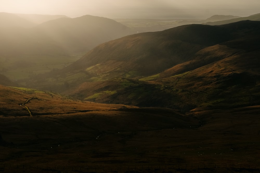 a view of a valley with mountains in the background