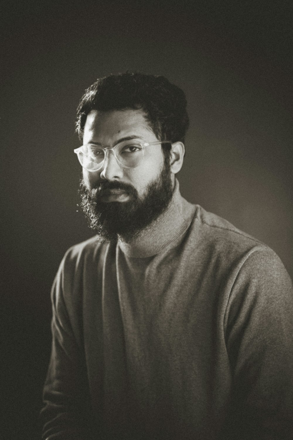 a black and white photo of a man with a beard