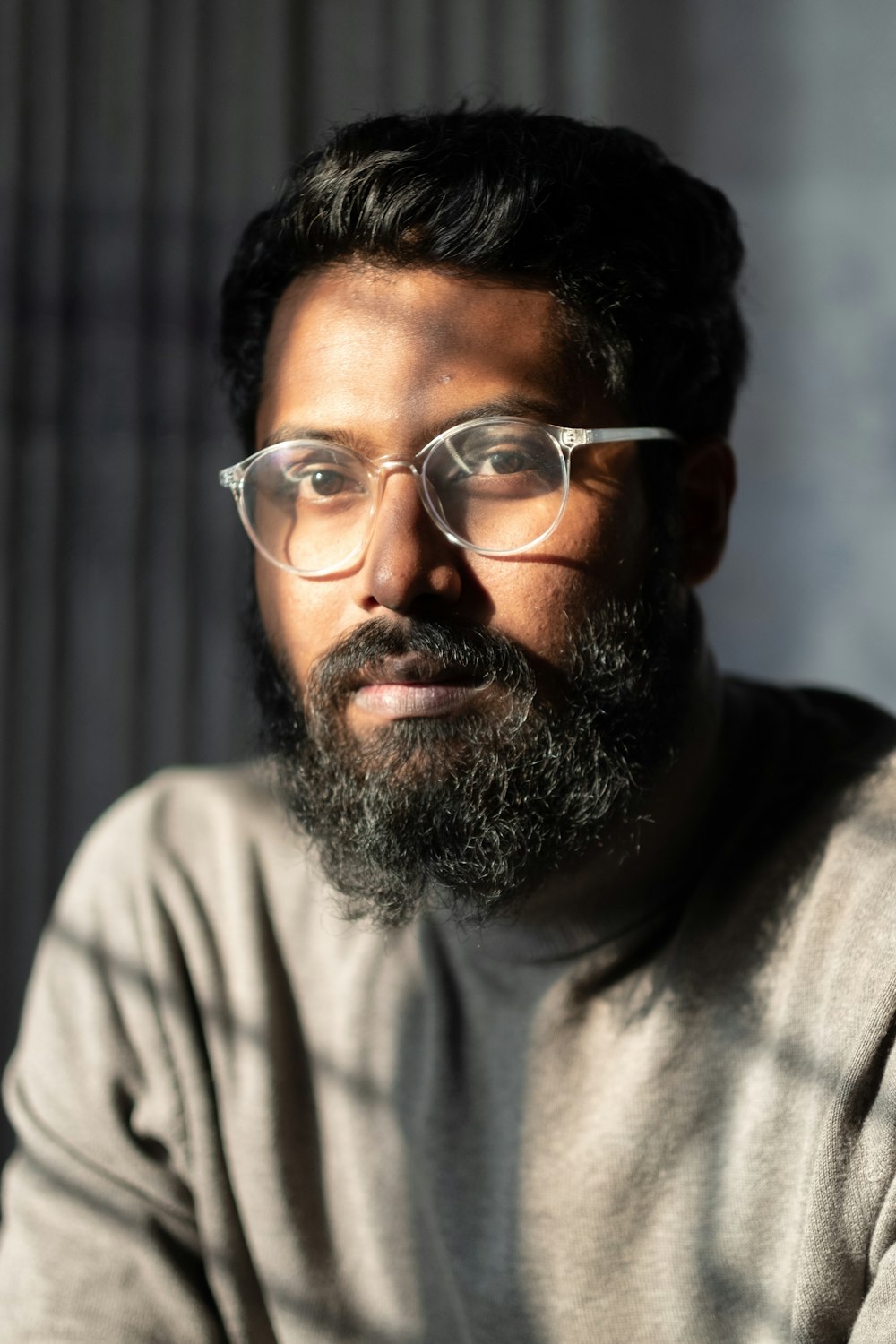 a man with a beard wearing glasses