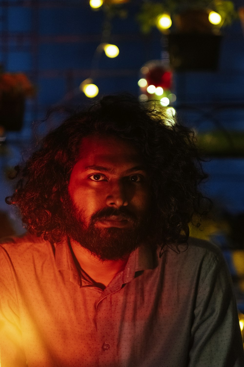 a man with long hair and a beard sitting at a table