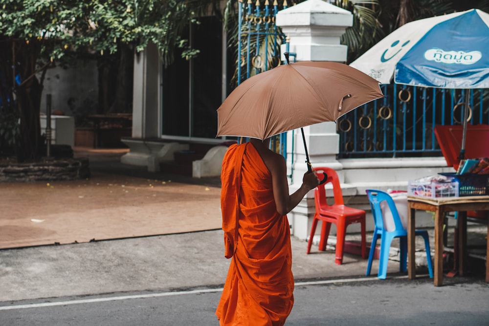 a person walking down a street holding an umbrella