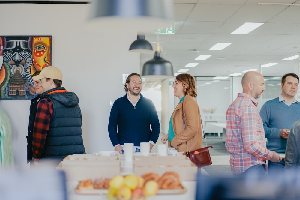 a group of people standing around a table