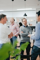 a group of men standing around a kitchen