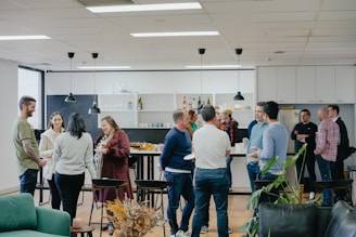 a group of people standing around in a room
