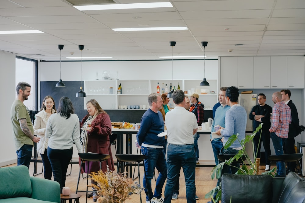 a group of people standing around in a room