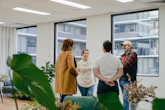 a group of people standing in an office