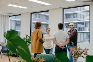 a group of people standing in an office