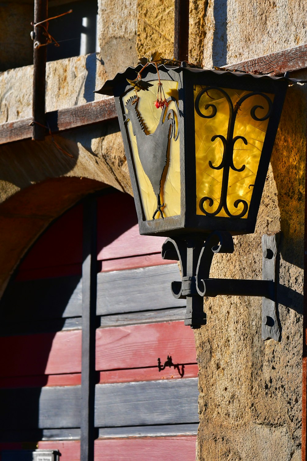 a yellow light hanging from the side of a building