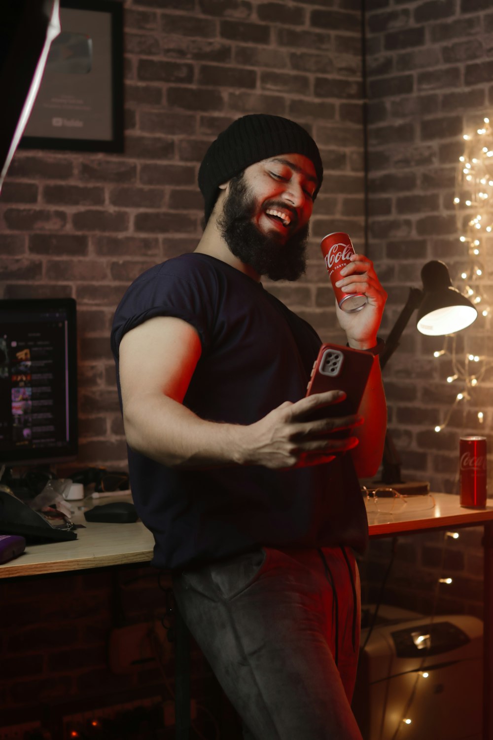 a man with a beard holding a bottle of beer