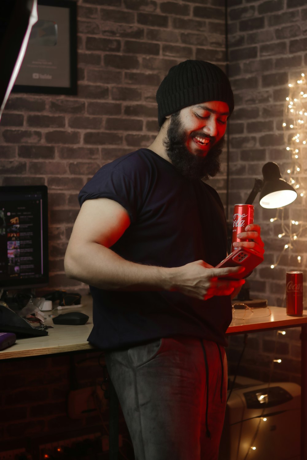 a man with a beard holding a can of soda