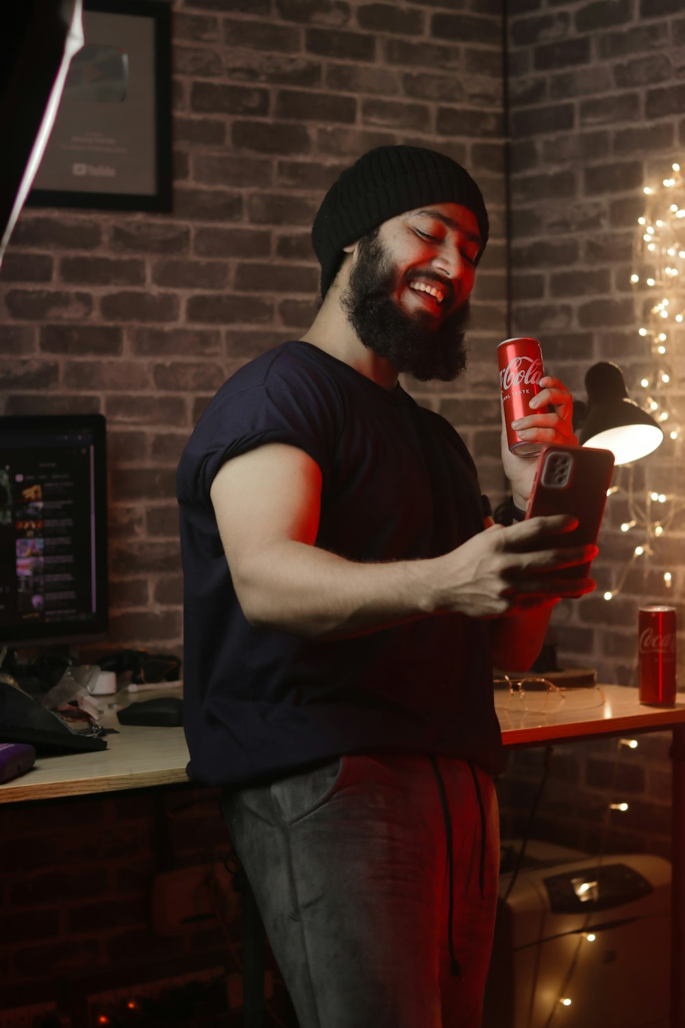 a man with a beard holding a can of soda