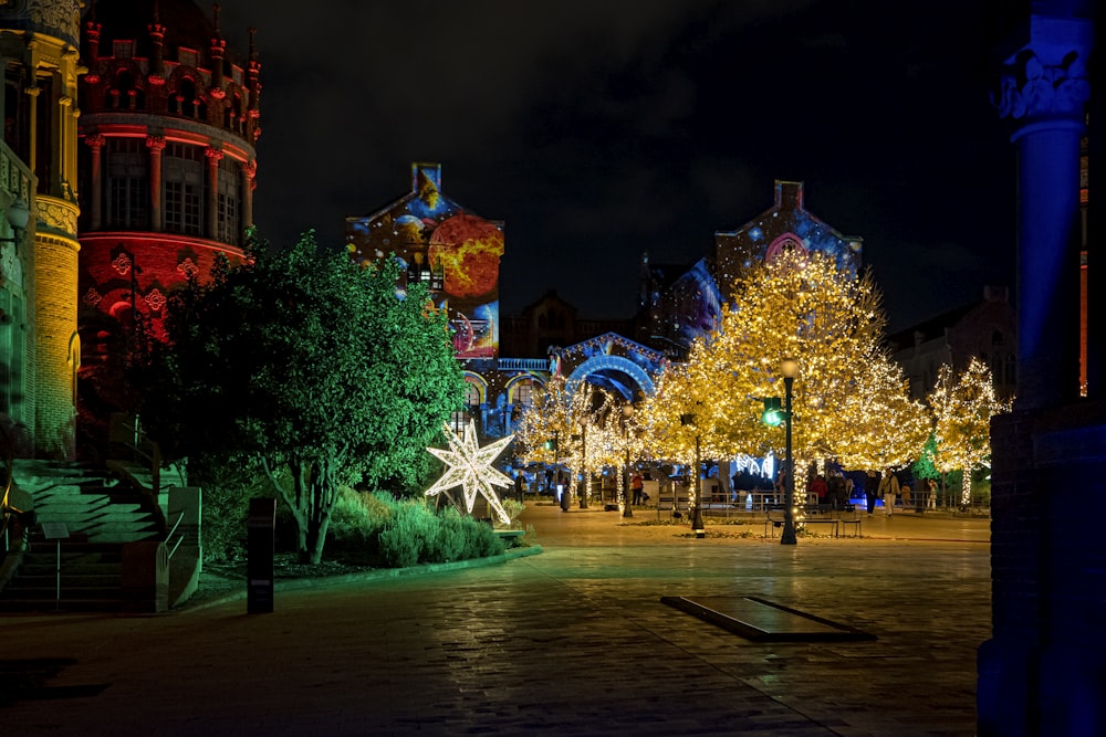 a city street at night decorated with christmas lights