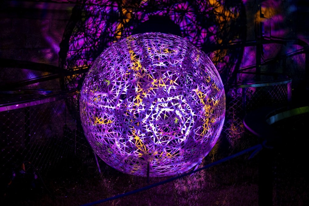 a purple ball sitting on top of a wooden table