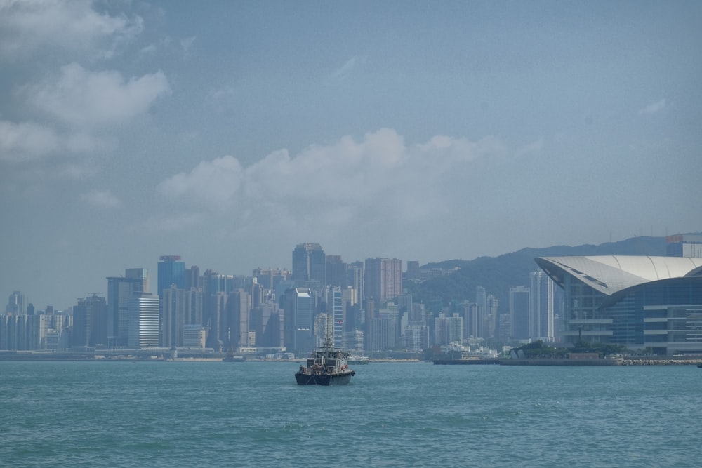 a boat is in the water near a city