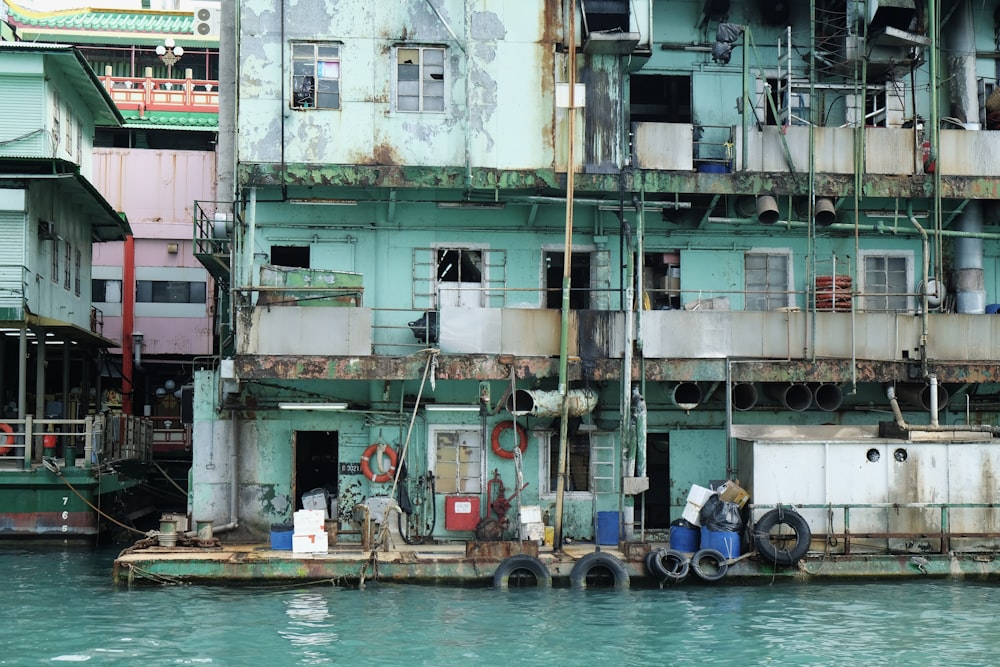 a large building with a bunch of windows next to a body of water