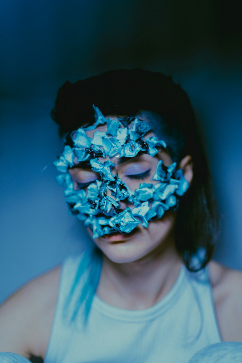 a young girl with a blue mask on her face