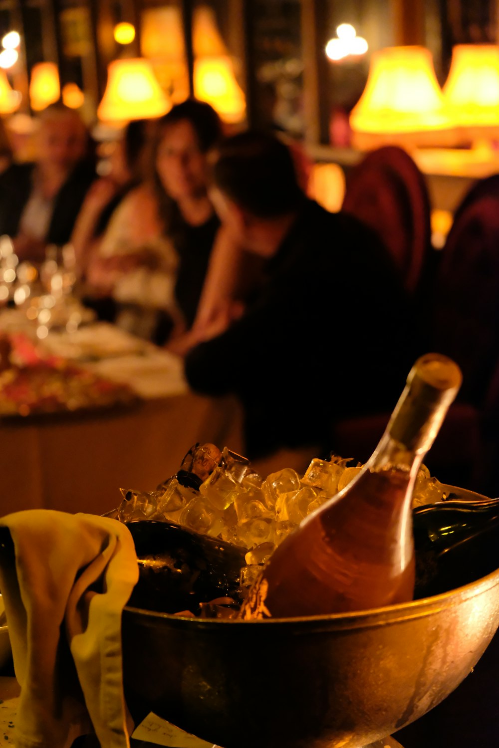 a bottle of wine in a bowl on a table