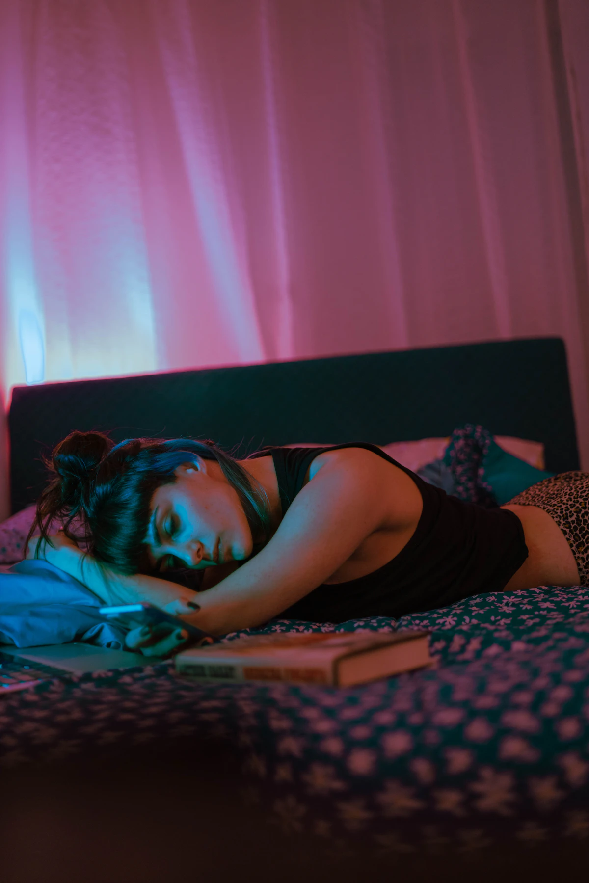 Woman resting with a book, representing disrupted sleep in the luteal phase