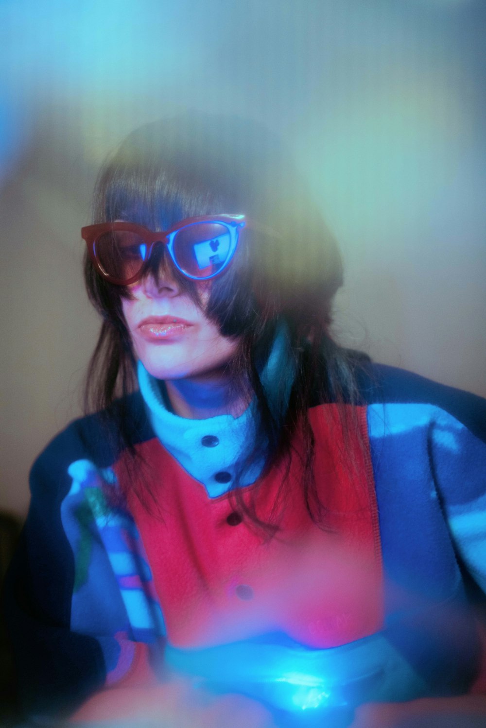 a woman wearing sunglasses sitting at a table