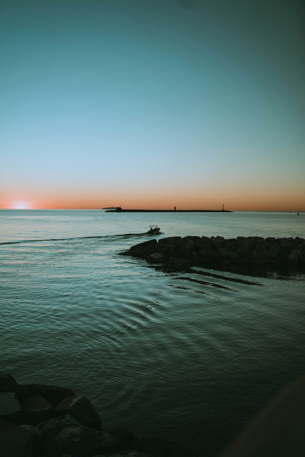 a body of water with a boat in the distance