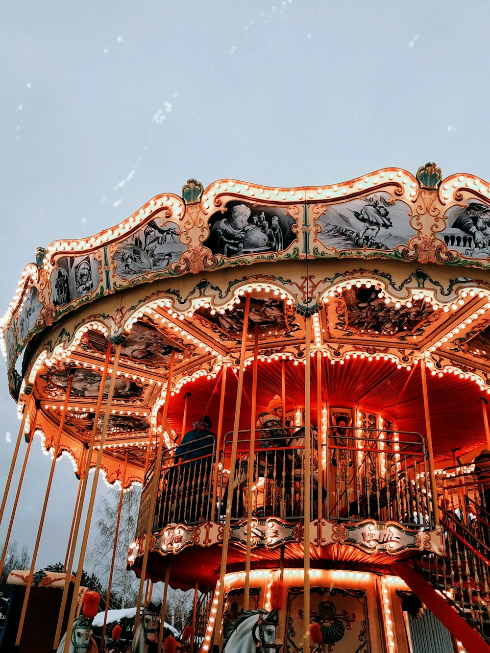 a merry go round is lit up at night