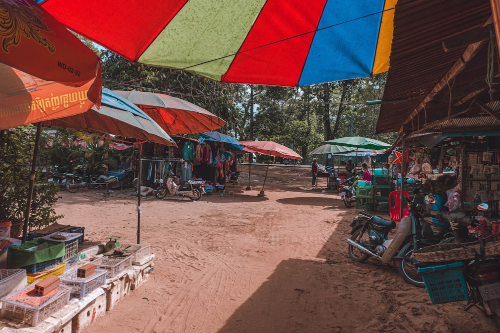 a bunch of umbrellas that are in the dirt