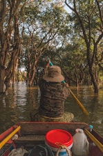 a person riding in a boat on a river