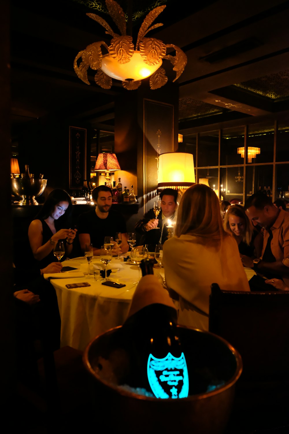 a group of people sitting at a table in a restaurant