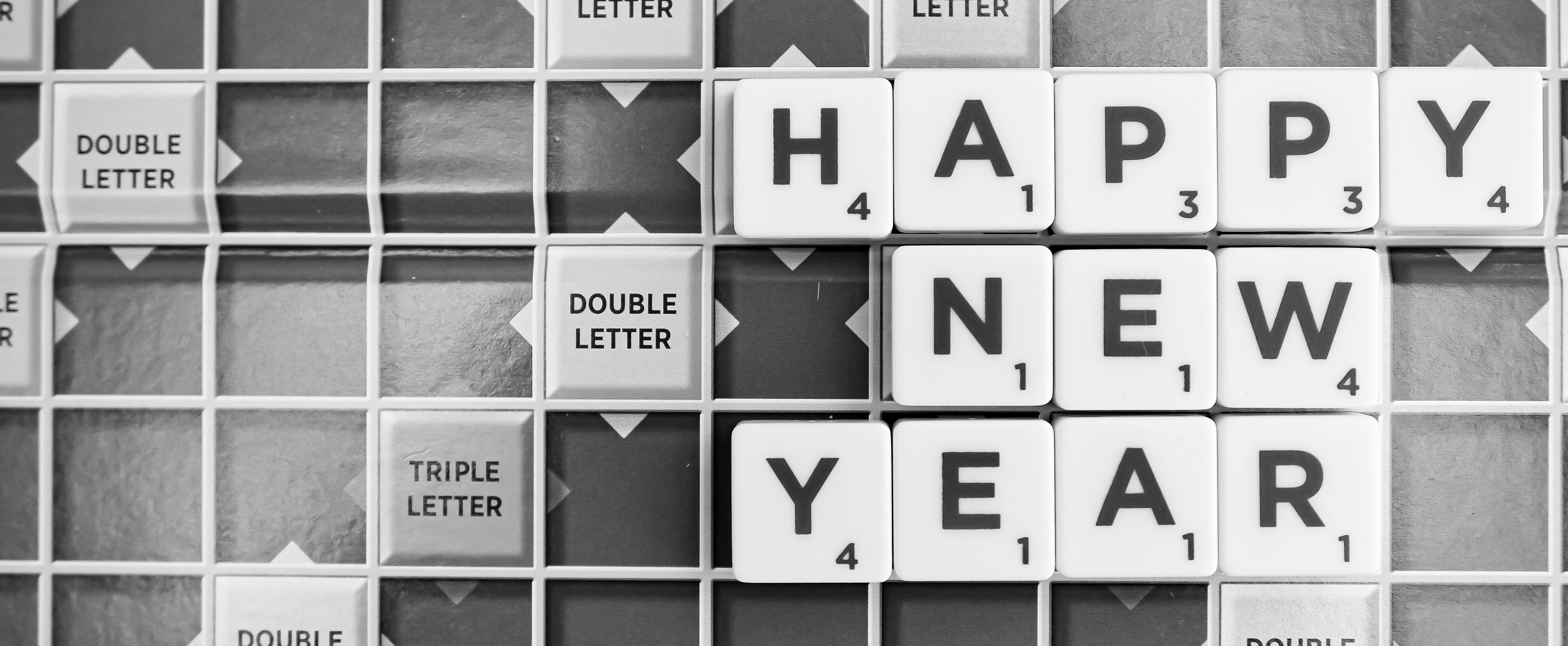 Happy New Year in mono on a scrabble board