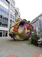 A vibrant montage of various scrap objects assembled into a striking art piece displayed outdoors.