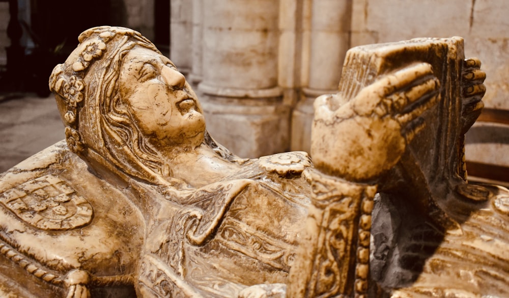 a statue of a man holding a book