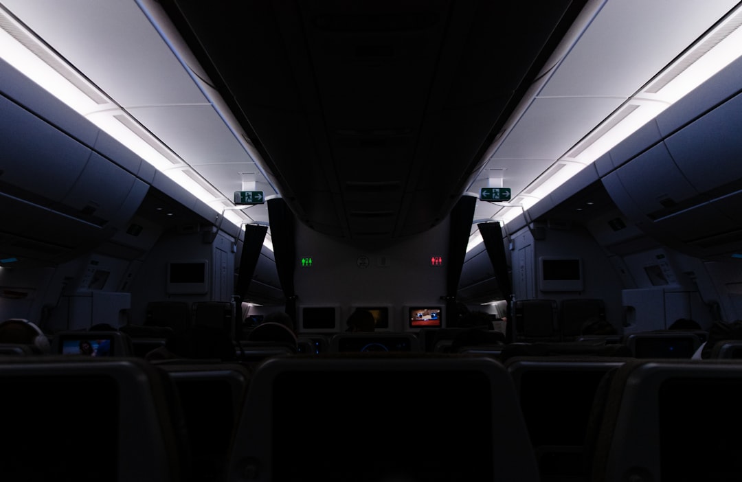 the interior of an airplane with the lights on,