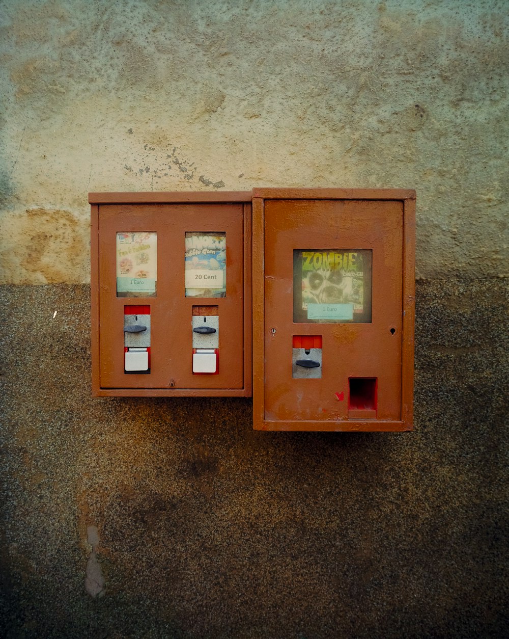 a couple of orange boxes sitting on the side of a building